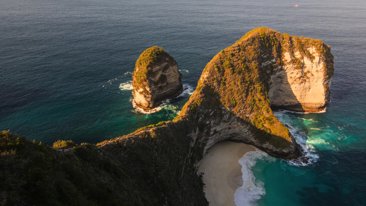 Kelingking Beach cliff on Nusa Penida, an island off Bali's coast, at golden hour